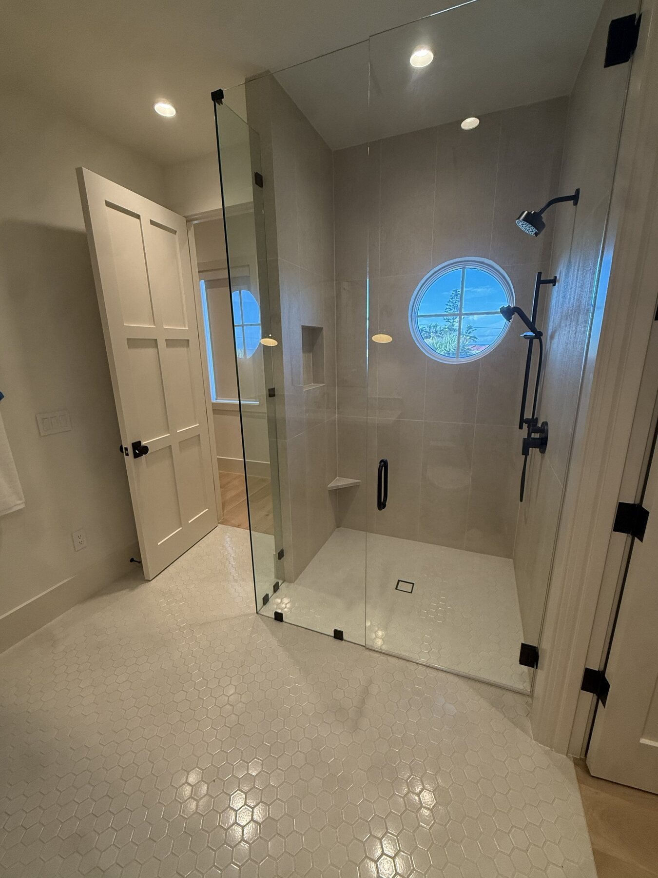 Custom glass shower with tiled walls