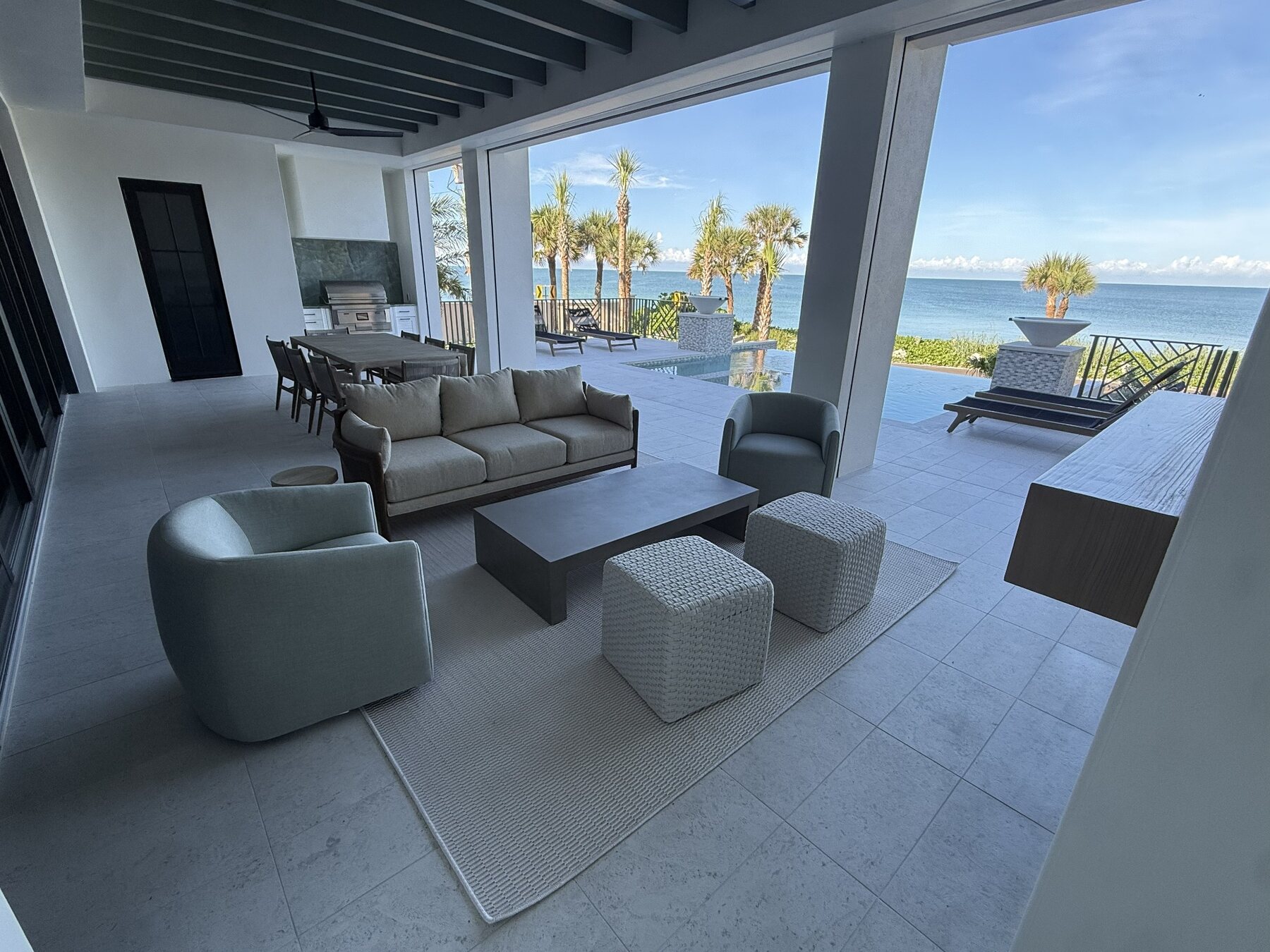 Waterfront terrace with large-format tile flooring
